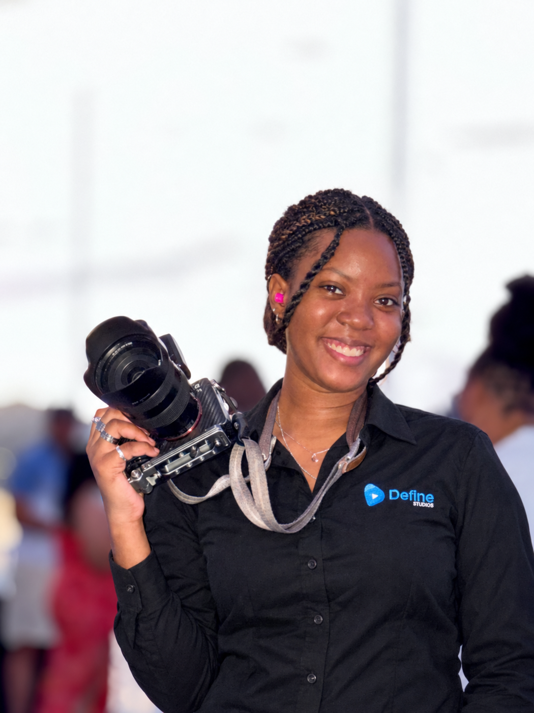 Alexa Joseph holding a camera in her Define Studios shirt