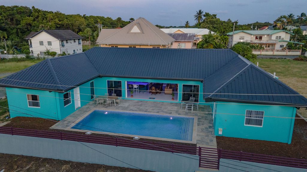 Turquoise Tobago house and pool courtyard seen from above.